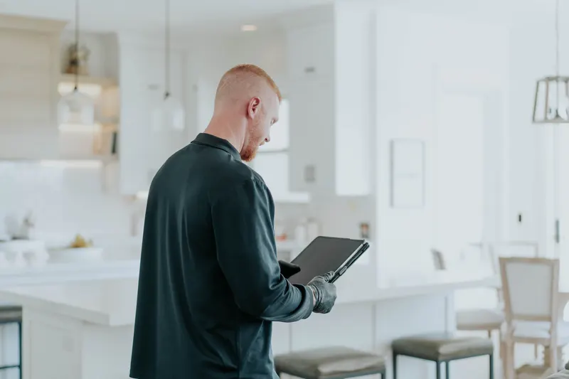 Inspector reviewing findings on tablet